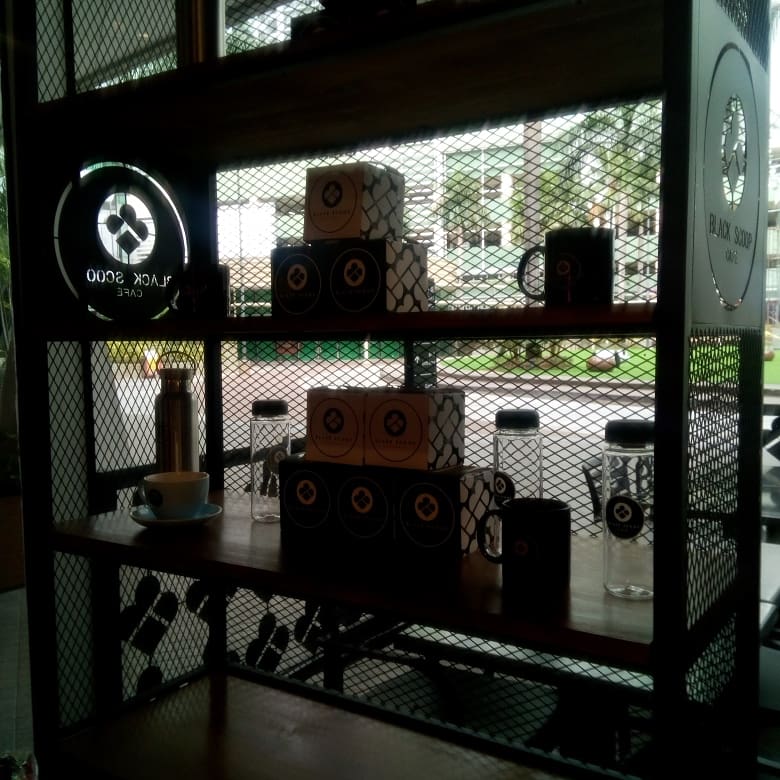 shelves with Black Scoop Cafe merchandise 
