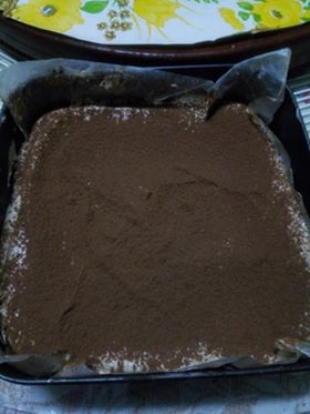 Graham crackers covered in coffee-cream mixture and dusted cocoa powder 
